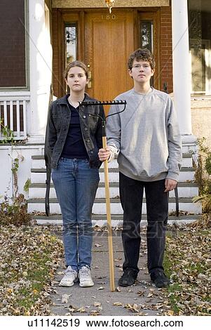 Stock Photo - Teen brother and sister in American Gothic pose, Winnipeg, Canada. Fotosearch