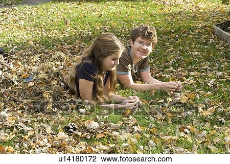 Teen brother and sister lying in leaves viewed from side, Winnipeg, Canada View Large Photo Image Stock Image - Teen brother and sister lying in leaves viewed from side, Winnipeg, Canada. Fotosearch