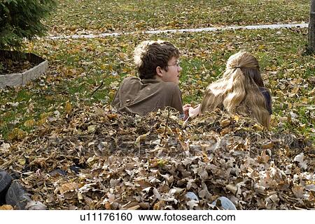 Teen brother and sister lying in leaves, viewed from behind, Winnipeg, Canada View Large Photo Image Stock Image - Teen brother and sister lying in leaves, viewed from behind, Winnipeg, Canada. Fotosearch