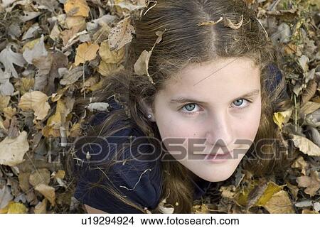 Teen girl lying in leaves, Winnipeg, Canada View Large Photo Image Picture - Teen girl lying in leaves, Winnipeg, Canada. Fotosearch