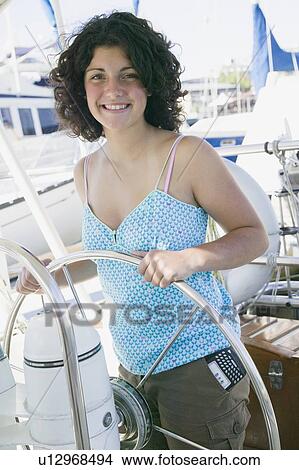 14 Year Old Girl at a Sailboat Helm. Blackberry Device in Pocket. Victoria, BC. View Large Photo Image Picture - 14 Year Old Girl at a Sailboat Helm. Blackberry Device in Pocket. Victoria, BC.. Fotosearch
