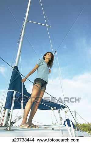 Woman standing on sailboat, wearing hemp shirt, Clear Lake, Riding Mountain National Park, Manitoba, Canada View Large Photo Image Picture - Woman standing on sailboat, wearing hemp shirt, Clear Lake, Riding Mountain National Park, Manitoba, Canada. Fotosearch
