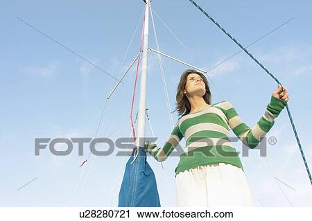 Woman with hand on mast and rope on sailboat, Clear Lake, Riding Mountain National Park, Manitoba, Canada View Large Photo Image Stock Image - Woman with hand on mast and rope on sailboat, Clear Lake, Riding Mountain National Park, Manitoba, Canada. Fotosearch
