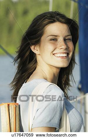 Young woman wearing hemp shirt, with hemp carry bag over her shoulder on sailboat, Clear Lake, Riding Mountain National Park, Manitoba, Canada View Large Photo Image Stock Photo - Young woman wearing hemp shirt, with hemp carry bag over her shoulder on sailboat, Clear Lake, Riding Mountain National Park, Manitoba, Canada. Fotosearch