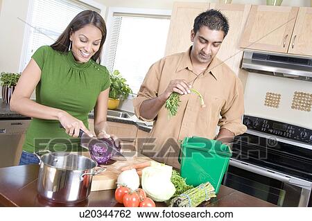 Couple in kitchen cutting vegetables beside kitchen compost bin, Winnipeg, Canada View Large Photo Image Stock Image - Couple in kitchen cutting vegetables beside kitchen compost bin, Winnipeg, Canada. Fotosearch