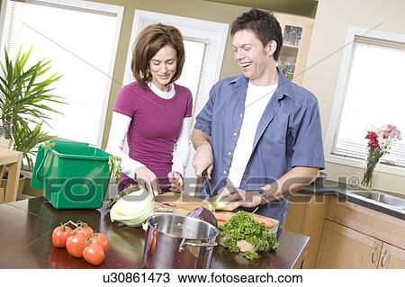 Couple in kitchen cutting vegetables beside kitchen compost bin, Winnipeg, Canada View Large Photo Image Stock Image - Couple in kitchen cutting vegetables beside kitchen compost bin, Winnipeg, Canada. Fotosearch