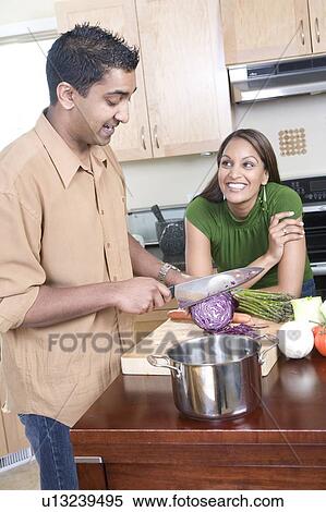 Couple in kitchen cutting vegetables, Winnipeg, Canada View Large Photo Image Stock Photography - Couple in kitchen cutting vegetables, Winnipeg, Canada. Fotosearch