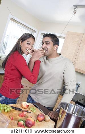 Couple in kitchen snacking on fresh fruit, beside stainless compost pail, Winnipeg, Canada View Large Photo Image Stock Image - Couple in kitchen snacking on fresh fruit, beside stainless compost pail, Winnipeg, Canada. Fotosearch