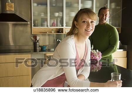 Stock Photograph - Couple in kitchen, Winnipeg, Canada. Fotosearch