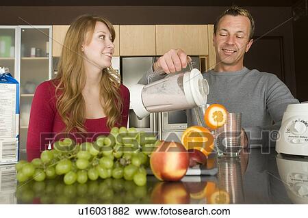 Couple pouring fruit smoothie made with organic fruit, Winnipeg, Canada View Large Photo Image Stock Image - Couple pouring fruit smoothie made with organic fruit, Winnipeg, Canada. Fotosearch