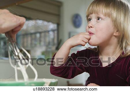 Stock Photo - Taste Testing Cup Cake Batter, Vancouver, B. C.. Fotosearch