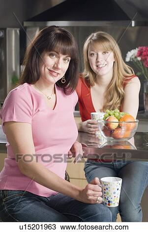 Two women seated in kitchen, Winnipeg, Canada View Large Photo Image Stock Image - Two women seated in kitchen, Winnipeg, Canada. Fotosearch