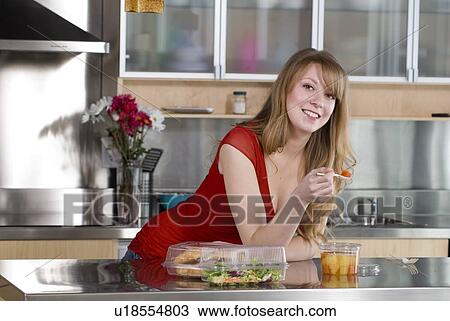 Woman eating take out food from containers and spoon made from corn, and which are fully compostable, Winnipeg, Canada View Large Photo Image Stock Image - Woman eating take out food from containers and spoon made from corn, and which are fully compostable, Winnipeg, Canada. Fotosearch