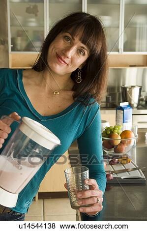 Woman with fruit drink made with organic fruit, Winnipeg, Canada View Large Photo Image Stock Photo - Woman with fruit drink made with organic fruit, Winnipeg, Canada. Fotosearch