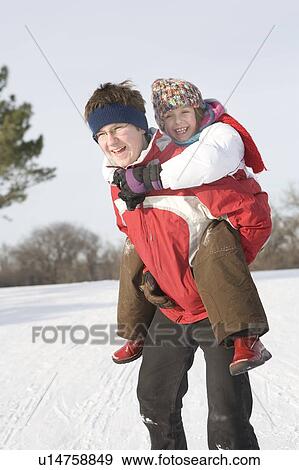 15 year old piggy-backs 9 year old girl, outdoor winter, Winnipeg, Canada View Large Photo Image Stock Photo - 15 year old piggy-backs 9 year old girl, outdoor winter, Winnipeg, Canada. Fotosearch
