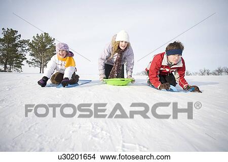 3 kids (14, 13 and 9 years old) sliding down hill, Winnipeg, Canada View Large Photo Image Picture - 3 kids (14, 13 and 9 years old) sliding down hill, Winnipeg, Canada. Fotosearch
