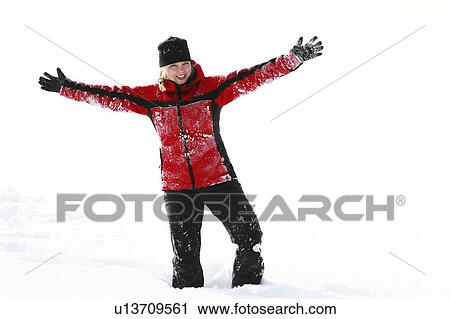 Stock Image - Blonde woman arms raised, cheerful expression.. Fotosearch