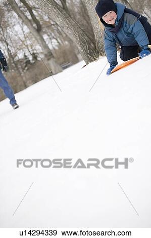 Stock Photo - Child on snow slider, Regina, Saskatchewan, Canada. Fotosearch