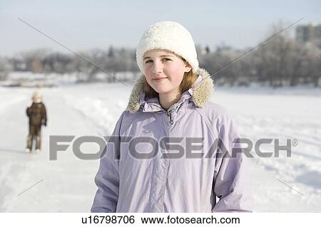 Stock Photograph - Portrait of 13 year old girl on ice skating trail, Red River, Winnipeg, Canada. Fotosearch