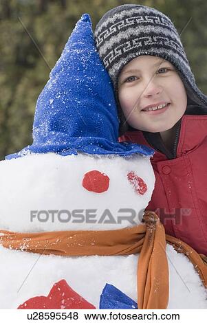 Ten year old boy beside snowman, Winnipeg, Canada View Large Photo Image Stock Photo - Ten year old boy beside snowman, Winnipeg, Canada. Fotosearch