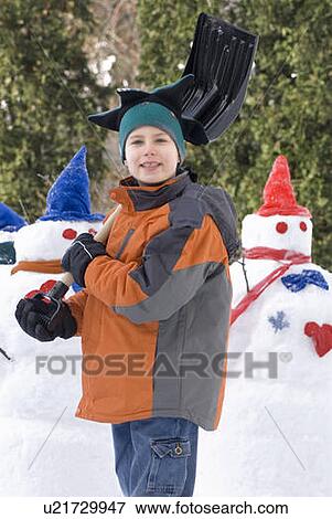 Ten year old boy with shovel beside snowmen, Winnipeg, Canada View Large Photo Image Stock Photo - Ten year old boy with shovel beside snowmen, Winnipeg, Canada. Fotosearch