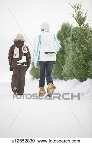 Two girls (9 and 13) with skates walking along frozen Assiniboine River skating trail, Winnipeg, Canada View Large Photo Image Stock Image - Two girls (9 and 13) with skates walking along frozen Assiniboine River skating trail, Winnipeg, Canada. Fotosearch