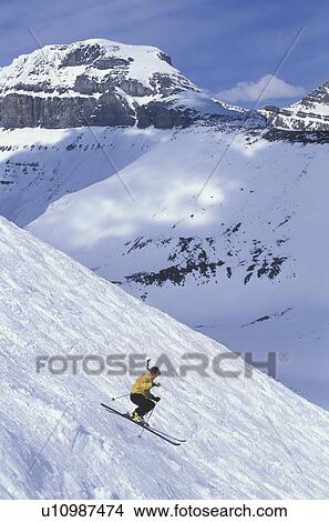Picture - Young woman skiing in the bumps at Lake Louise Resort, Alberta, Canada.. Fotosearch