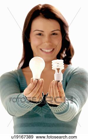 Stock Photo - Young girl w/Light bulb, Regina, Saskatchewan. Fotosearch