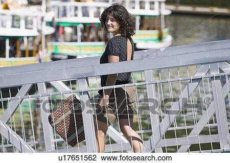 Stock Image - 14 Year Old Girl walking down the ramp to the public docks in Victoria BC. Fotosearch