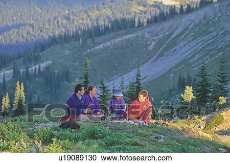 Stock Image - Family enjoys an evening picnic on Whistler Mountain, BC. Fotosearch