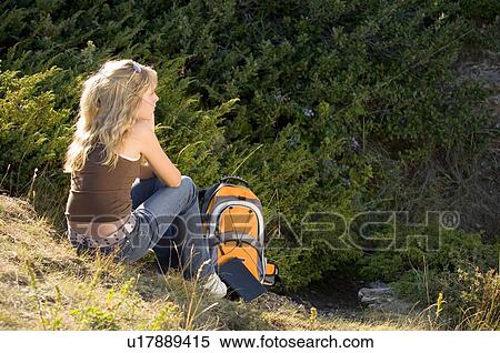 Female teen seated outdoors with backpack and book, Saskatchewan View Large Photo Image Stock Photography - Female teen seated outdoors with backpack and book, Saskatchewan. Fotosearch