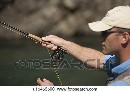 Stock Image - Fly-fishing guide, Russ Trand, fly-fishing on tributary of Elk River near Fernie, Elk Valley, East Kootenays, British Columbia, Canada.. Fotosearch
