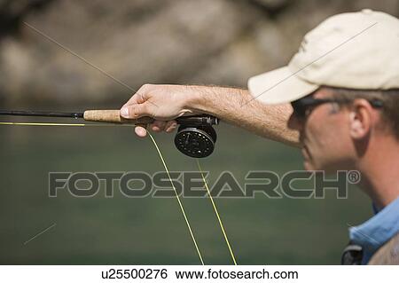 Stock Photograph - Fly-fishing guide, Russ Trand, fly-fishing on tributary of Elk River near Fernie, Elk Valley, East Kootenays, British Columbia, Canada.. Fotosearch