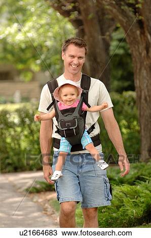 man carrying baby