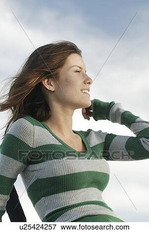 Stock Photo - Profile of young woman outdoors, Clear Lake, Riding Mountain National Park, Manitoba, Canada. Fotosearch