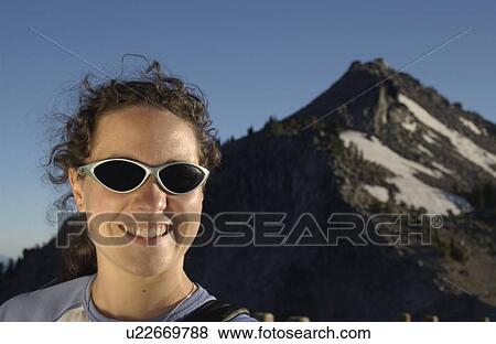 Woman (20-25) with sunglasses in front of mountains, Crater Lake National Park, Oregon View Large Photo Image Stock Photo - Woman (20-25) with sunglasses in front of mountains, Crater Lake National Park, Oregon. Fotosearch