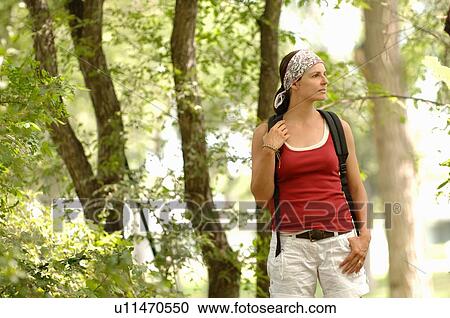 Stock Image - Woman hiking in woods, Regina, Saskatchewan. Fotosearch