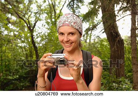 Woman in woods with camera, Regina, Saskatchewan View Large Photo Image Stock Photo - Woman in woods with camera, Regina, Saskatchewan. Fotosearch