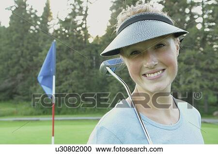 Stock Image - Woman on organic golf course, Clear Lake Golf Course, Riding Mountain National Park, Manitoba, Canada. Fotosearch