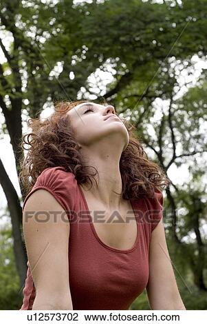 Woman stretches her upper body upward, Munson Park, Winnipeg, Canada View Large Photo Image Stock Image - Woman stretches her upper body upward, Munson Park, Winnipeg, Canada. Fotosearch