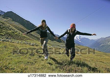 Stock Image - Young girls (19) hiking in front of Mont Blanc, Col de Balme Chamonix, France. Fotosearch