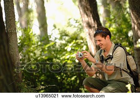 Young man in woods w/ camera, Regina, Saskatchewan View Large Photo Image Stock Image - Young man in woods w/ camera, Regina, Saskatchewan. Fotosearch