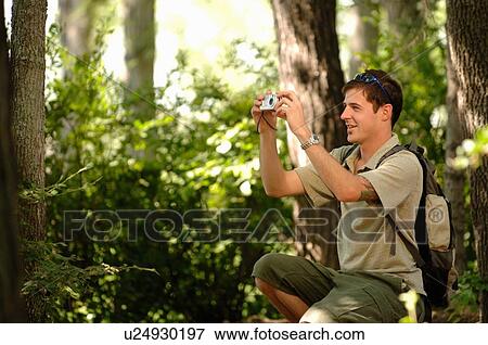 Young man in woods w/ camera, Regina, Saskatchewan View Large Photo Image Stock Photo - Young man in woods w/ camera, Regina, Saskatchewan. Fotosearch