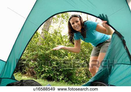 Young woman looking into opening of tent, Regina, Saskatchewan View Large Photo Image Stock Photo - Young woman looking into opening of tent, Regina, Saskatchewan. Fotosearch
