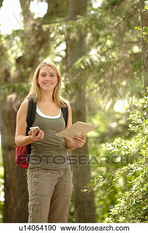 Young woman with gps type device and map in woods, Regina, Saskatchewan View Large Photo Image Stock Image - Young woman with gps type device and map in woods, Regina, Saskatchewan. Fotosearch