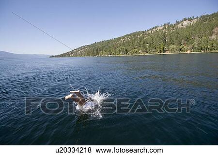 Youth diving into lake, Okanagan Centre, BC Canada. View Large Photo Image Stock Photo - Youth diving into lake, Okanagan Centre, BC Canada.. Fotosearch