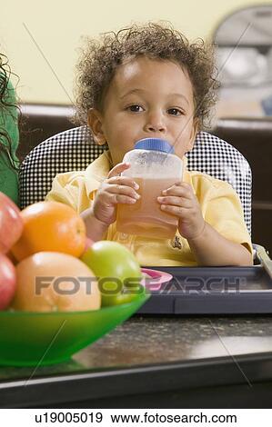 Stock Photo - 1. 5 year old Mulatto boy drinking juice.. Fotosearch