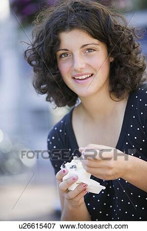 Stock Photo - 14 Year Old Girl Enjoying an Ice cream. Victoria, BC.. Fotosearch