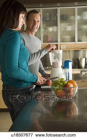 Couple making fruit smoothies with organic fruit, Winnipeg, Canada. View Large Photo Image Stock Photo - Couple making fruit smoothies with organic fruit, Winnipeg, Canada. . Fotosearch