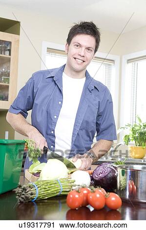 Man in kitchen cutting vegetables beside kitchen compost bin, Winnipeg, Canada View Large Photo Image Stock Image - Man in kitchen cutting vegetables beside kitchen compost bin, Winnipeg, Canada. Fotosearch